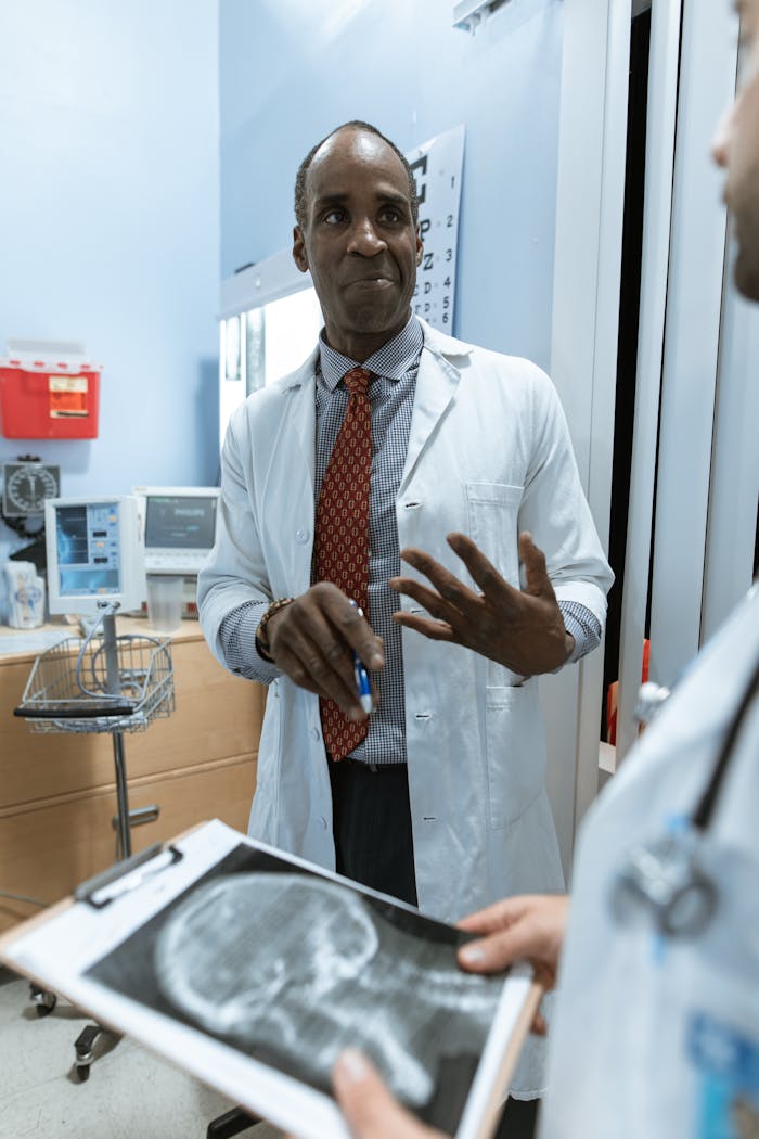 Medical practitioners analyzing x-ray results in a clinical setting.